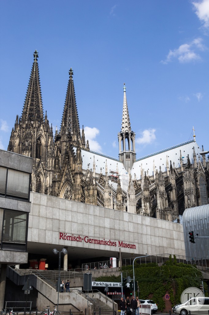 Cologne Cathedral spires tower over the Roman Germanic Museum and the city 