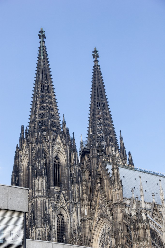 Twin spires peeking out over the roofline of Cologne Cathedral