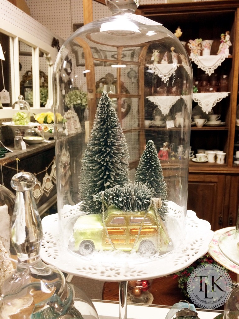 Bottle Brush Trees and an old car ornament under a cloche 